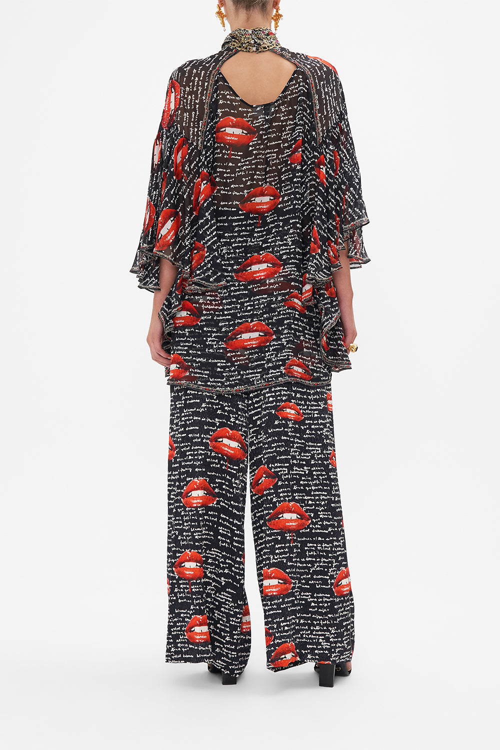 Back view of model wearing CAMILLA black silk blouse in Chaos Magic print