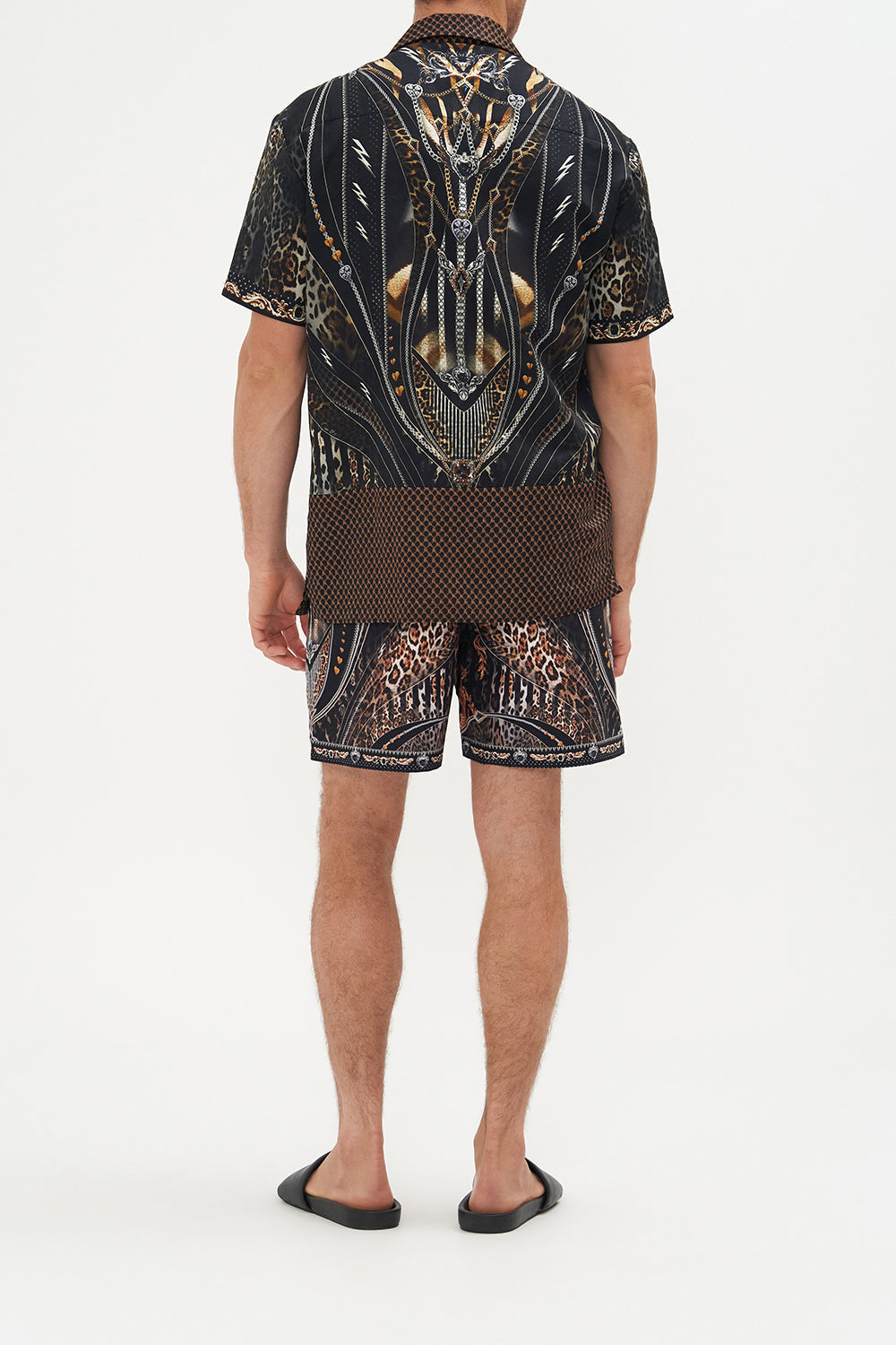 Back view of model wearing Hotel Franks by CAMILLA mens elastic waist boardshorts in Chaos In The Cosmos animal print