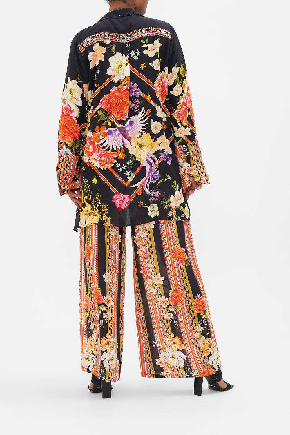 Back view of model wearing CAMILLA silk jacket in Secret History floral print