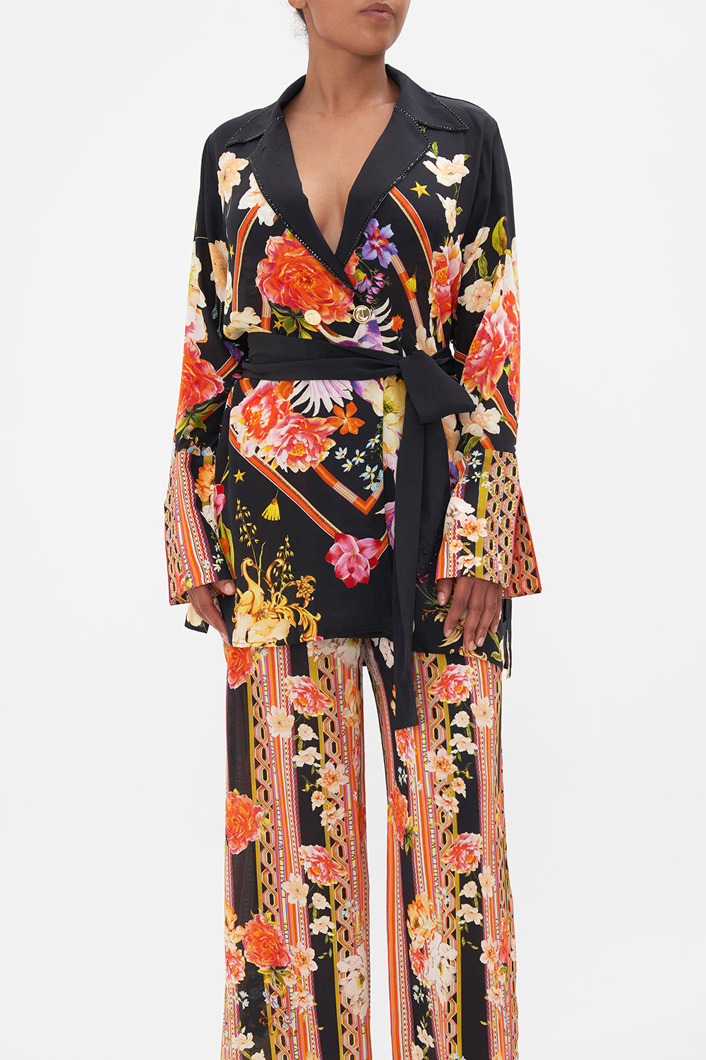 Crop view of model wearing CAMILLA silk jacket in Secret History floral print