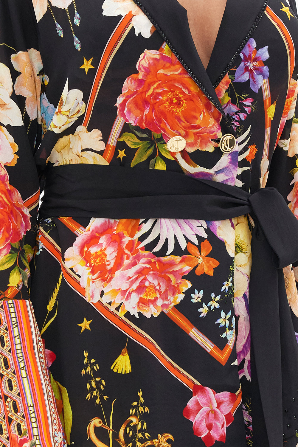 Detail view of model wearing CAMILLA silk jacket in Secret History floral print