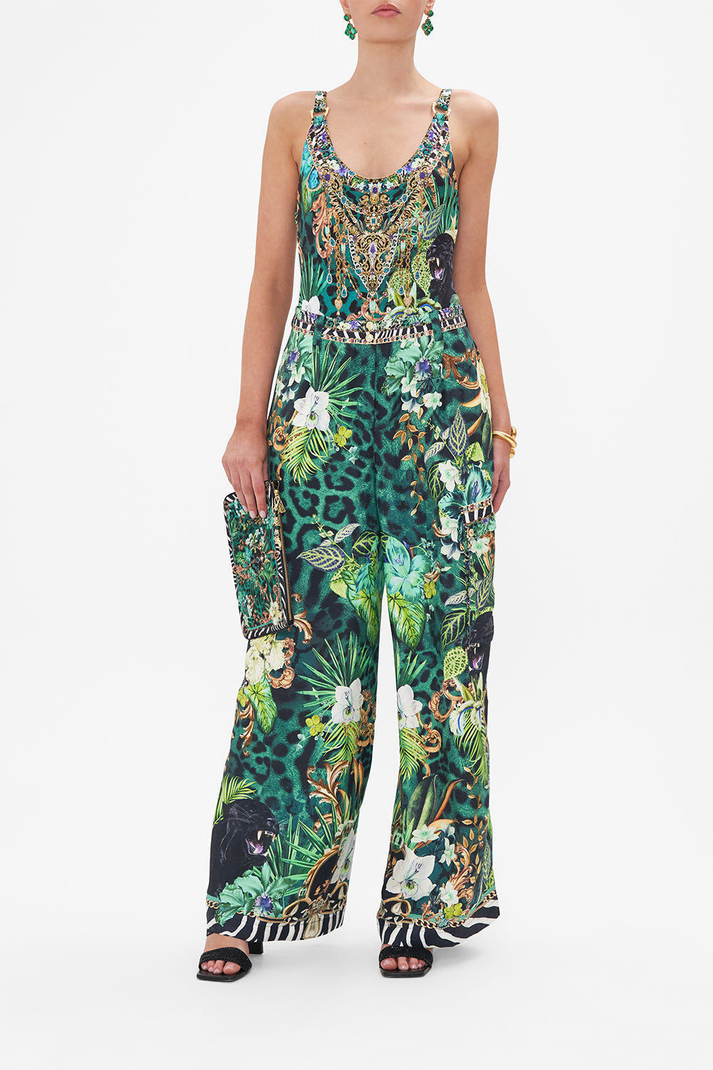 Front view of model wearing CAMILLA green silk cargo pants in Sing My Song print