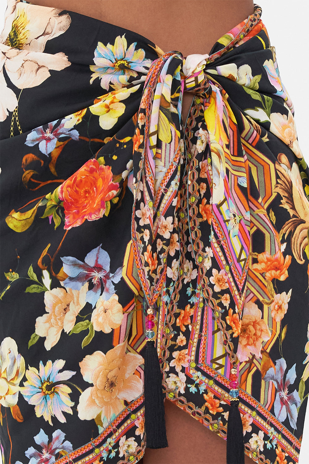 Detail view of model wearing CAMILLA silk cotton sarong in Wild Loving tropical print