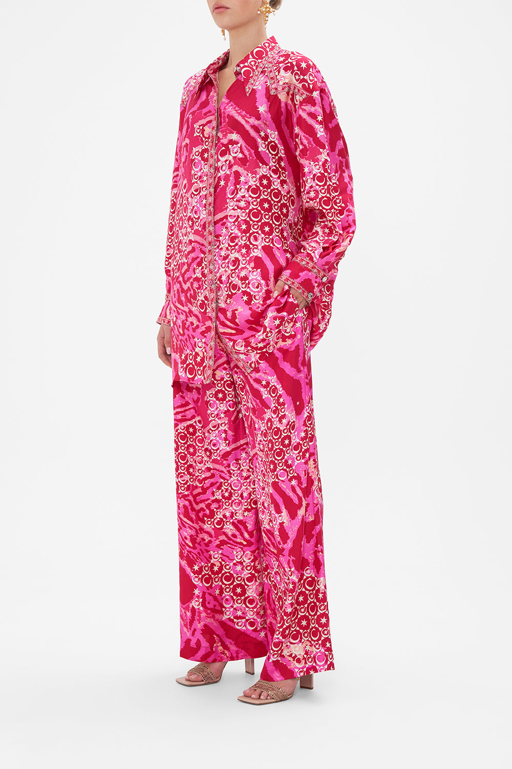 Side view of model wearing CAMILLA silk shirt in Song Of Sacrifice print