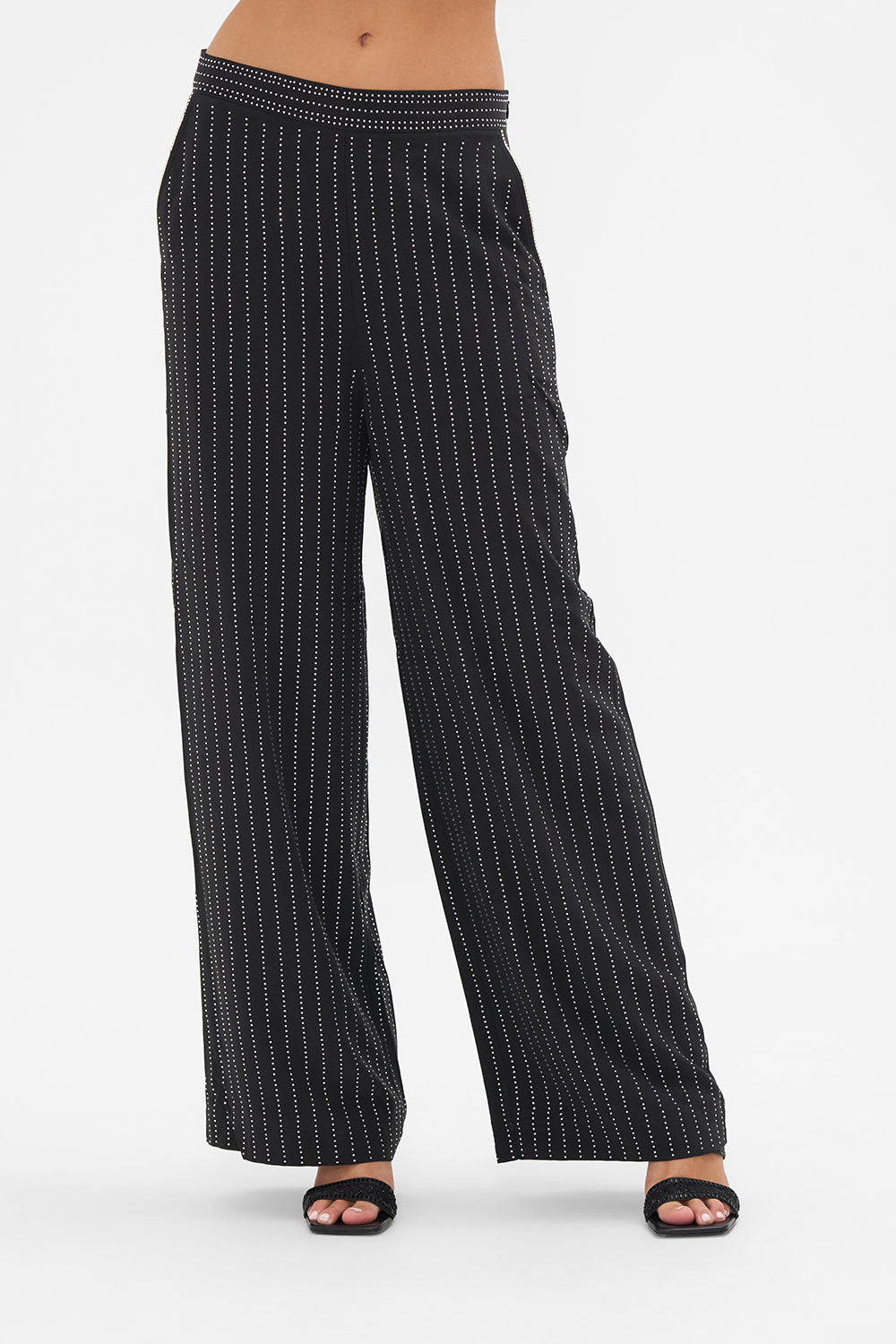 Crop view of model wearing CAMILLA floral silk pants in Curtain Call Chaos print