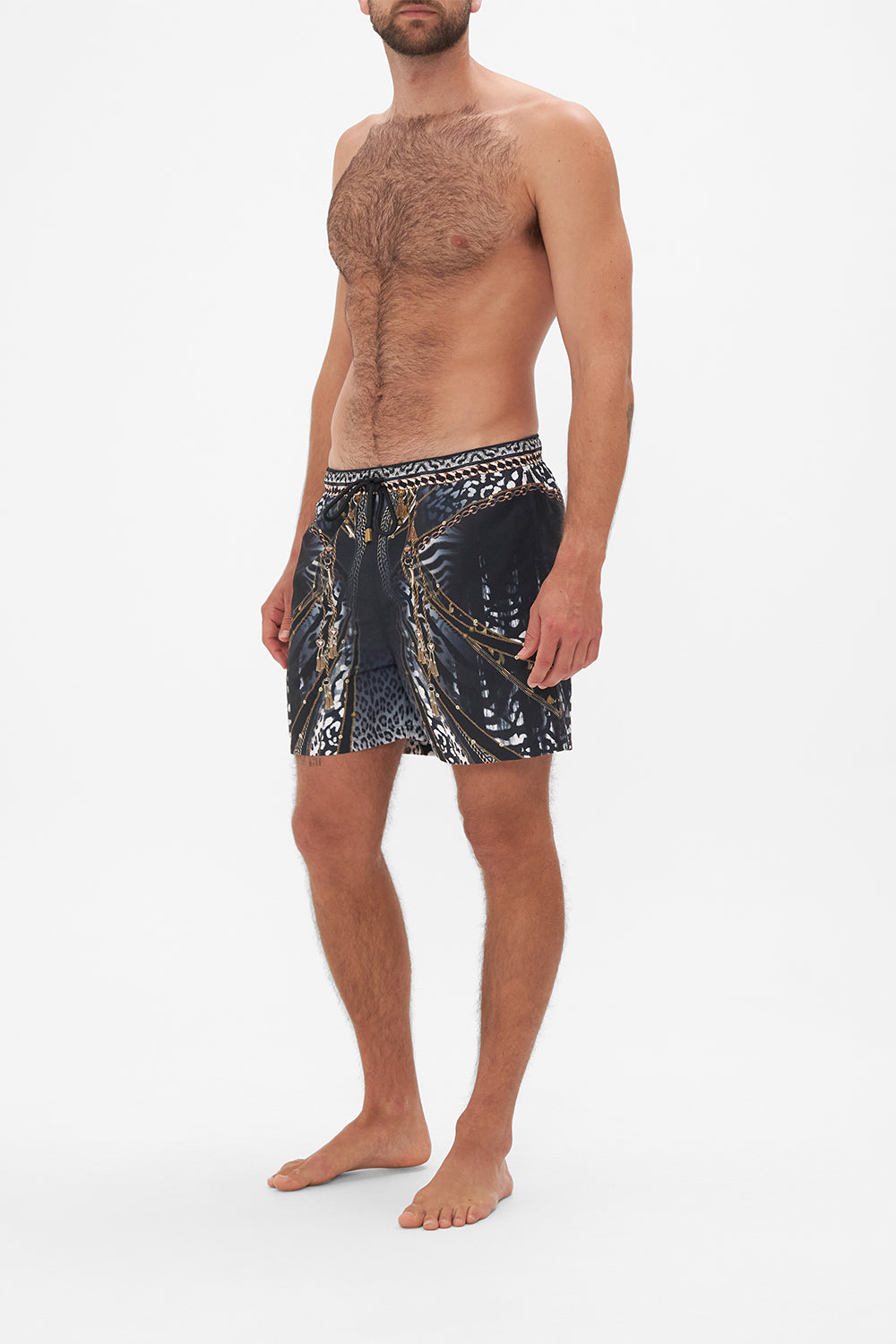 Side view of model wearing Hotel Franks by CAMILLA mens black boardshorts in Untamed Royalty print