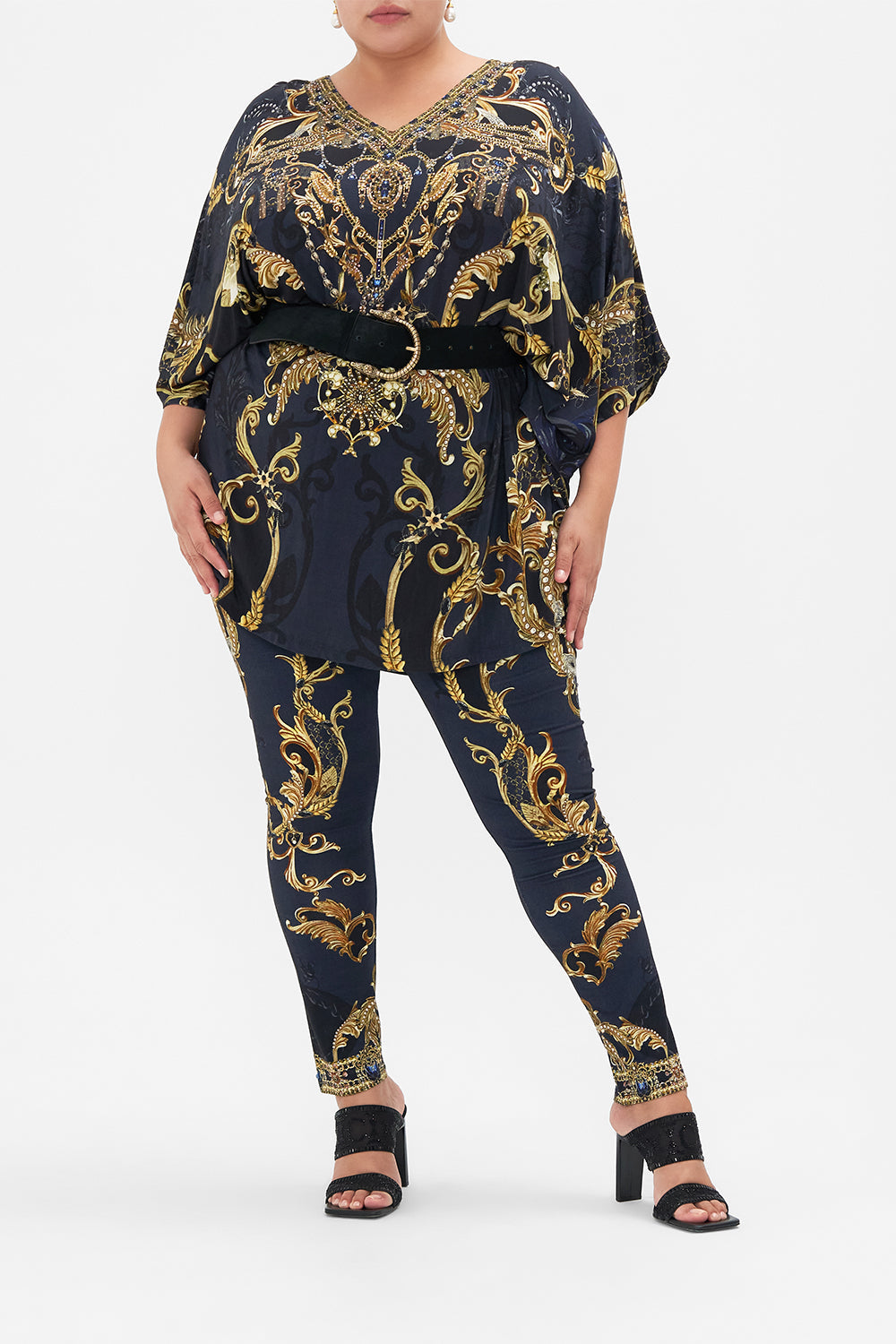 Front view of curvy model wearing CAMILLA plus size leggings in Moonlight Melodies print