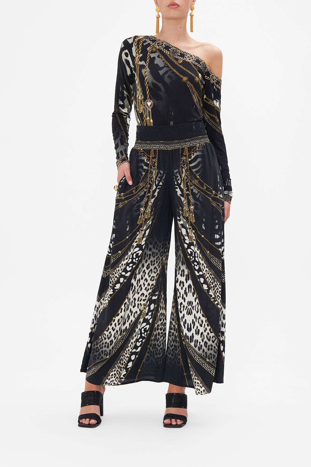Front view of model wearing CAMILLA black and white animal print silk pants in Untamed Royalty print
