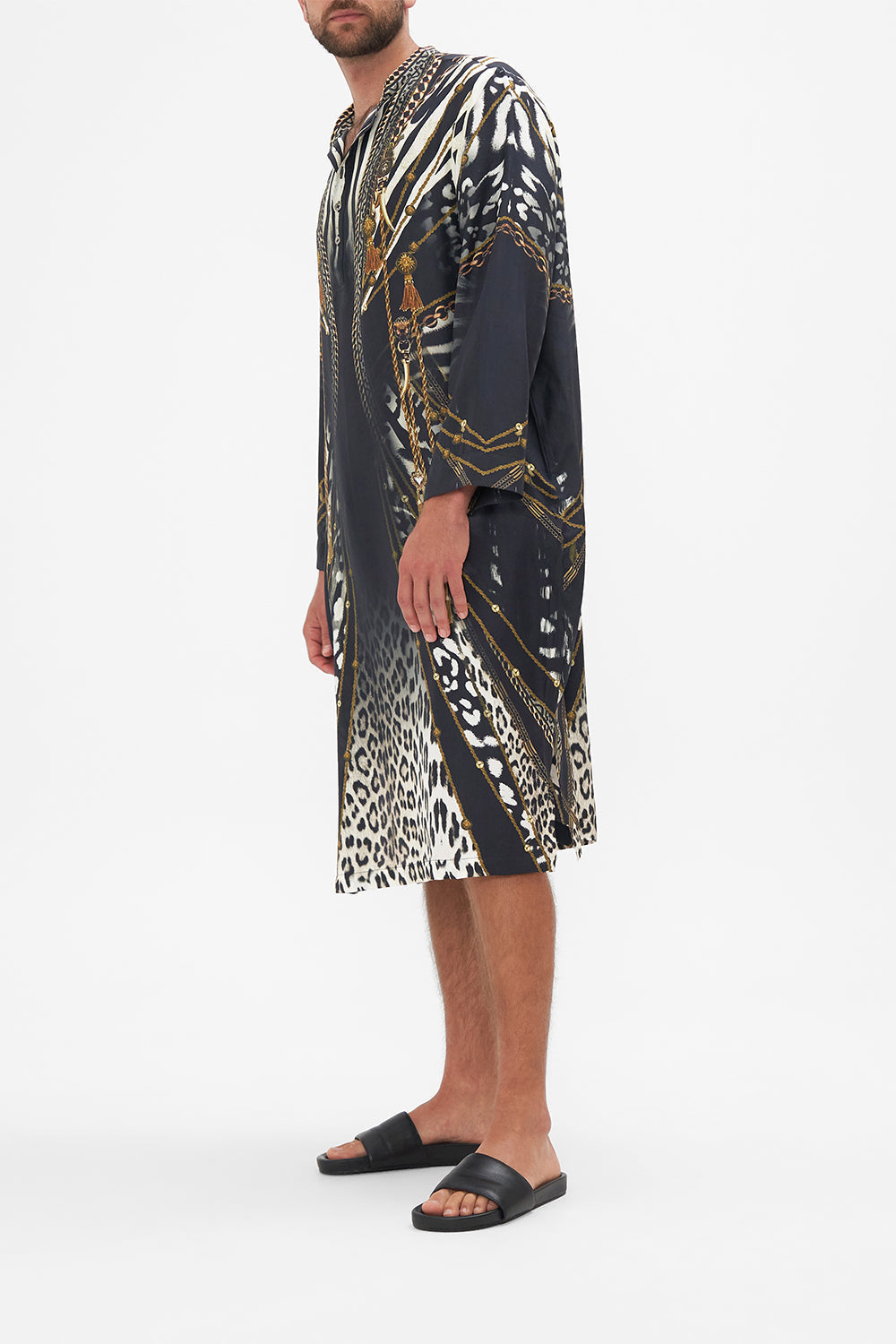 Side view of model wearing Hotel Franks by CAMILLA mens black silk kaftan in Untamed Royalty Print