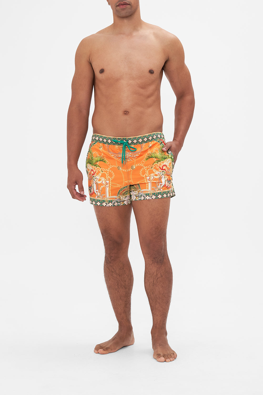 Front view of model wearing Hotel Franks by CAMILLA silk mens short boardshorts in orange Dancing With The Bulls print