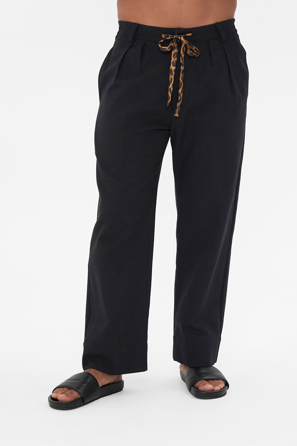 Crop view of model wearing Hotel Franks by CAMILLA mens black pleat front pants Jungle Dreaming