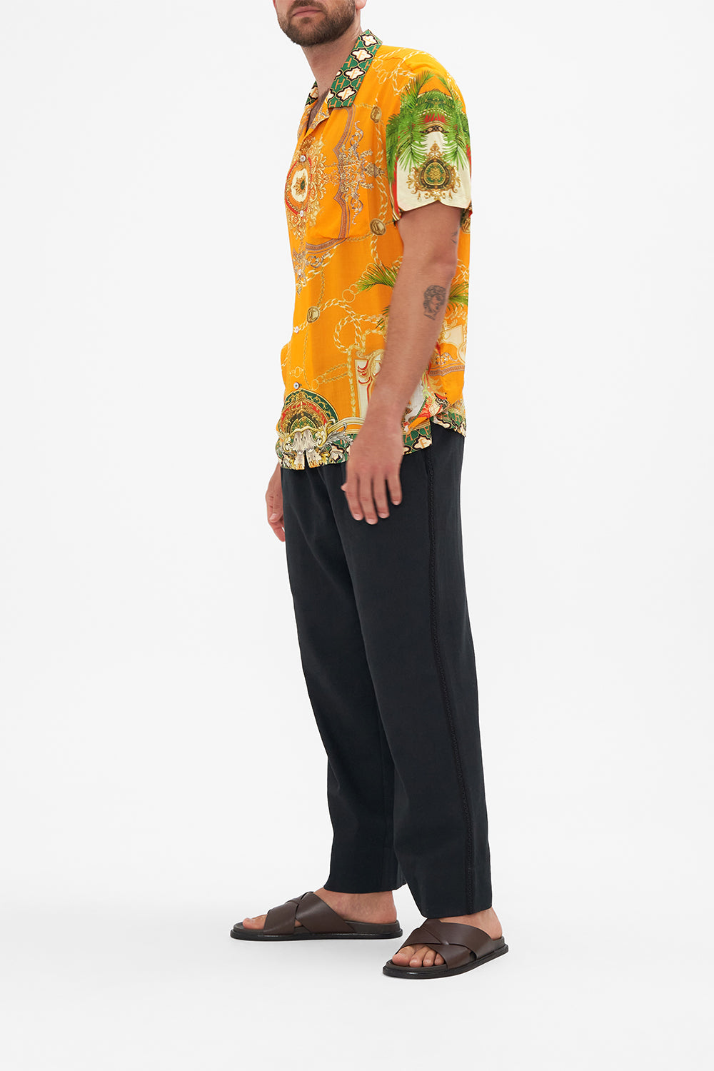 Side view of model wearing Hotel Franks by CAMILLA mens orange short sleeve camp collared shirt in Dancing With The Bulls print