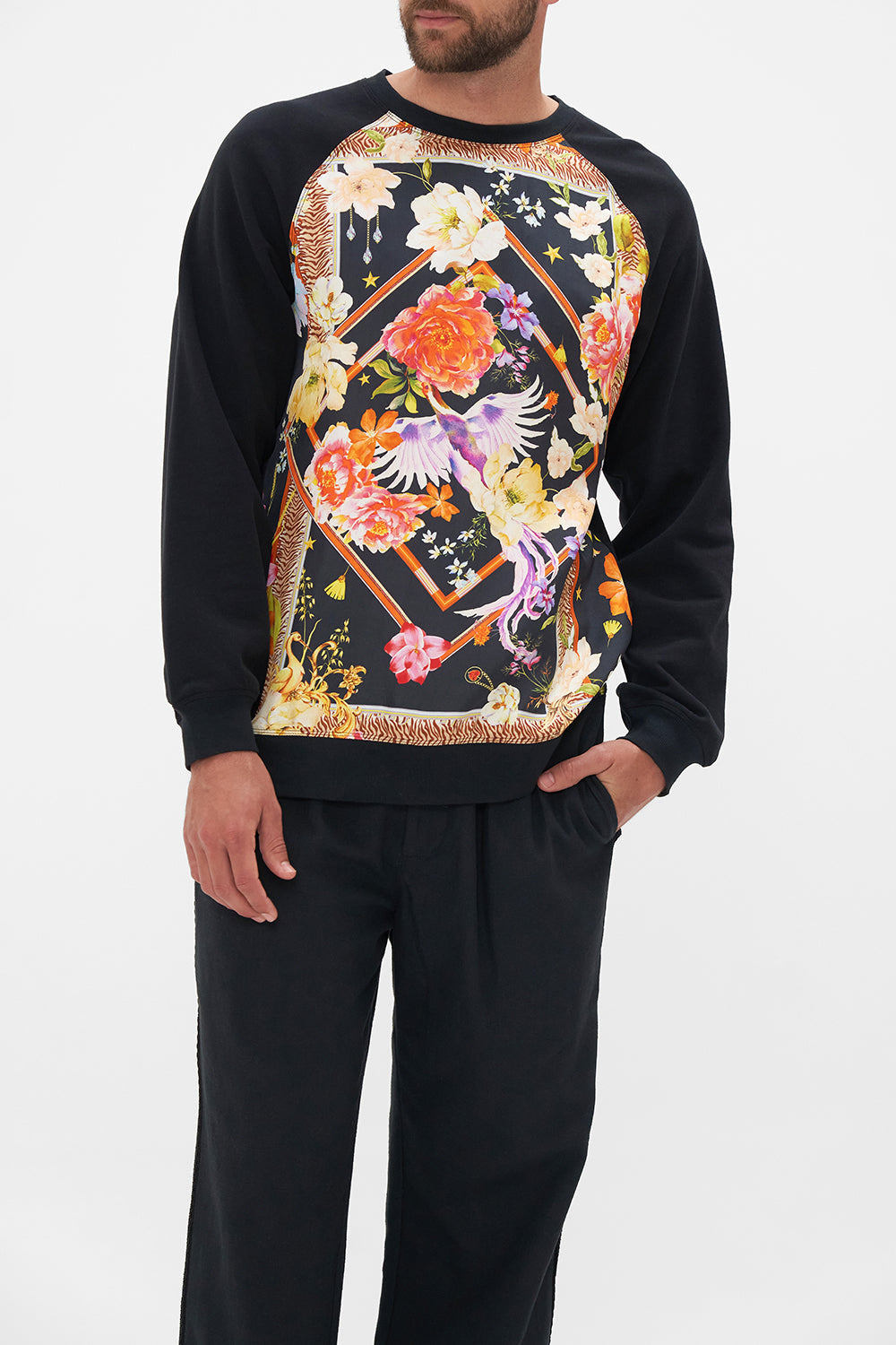 Crop view of model wearing Hotel Franks by CAMILLA silk mens black knit jumper in Secret History floral print