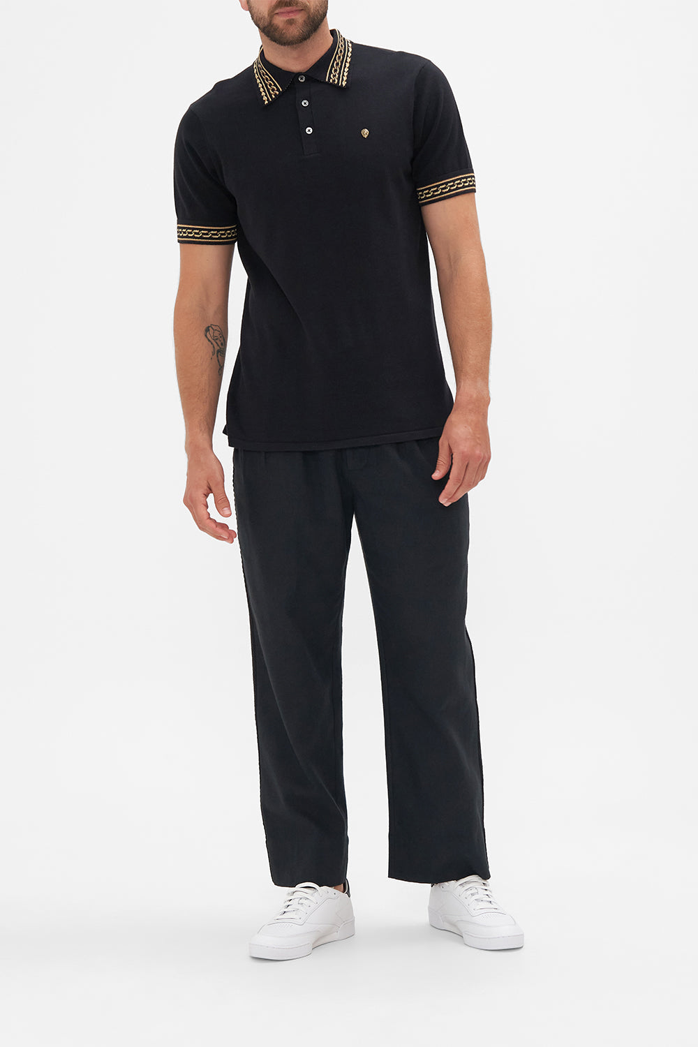 Front view of model wearing Hotel Franks by CAMILLA mens black polo shirt in Tether Me Not print