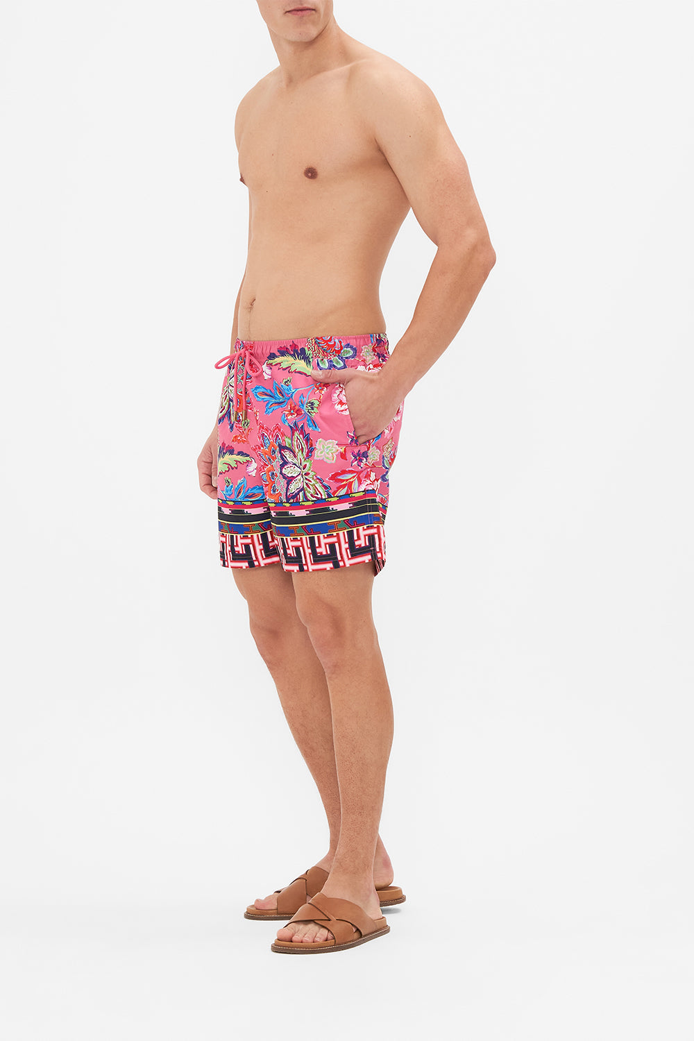 Side view of model wering HOTEL FRANKS BY CAMILLA mens boardshort in Rome Retro print