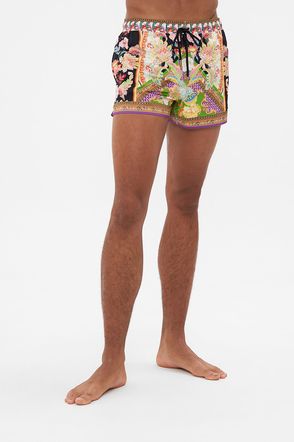 Crop view of model wearing Hotel Franks by CAMILLA mens swim short in Sundowners In Sicily print