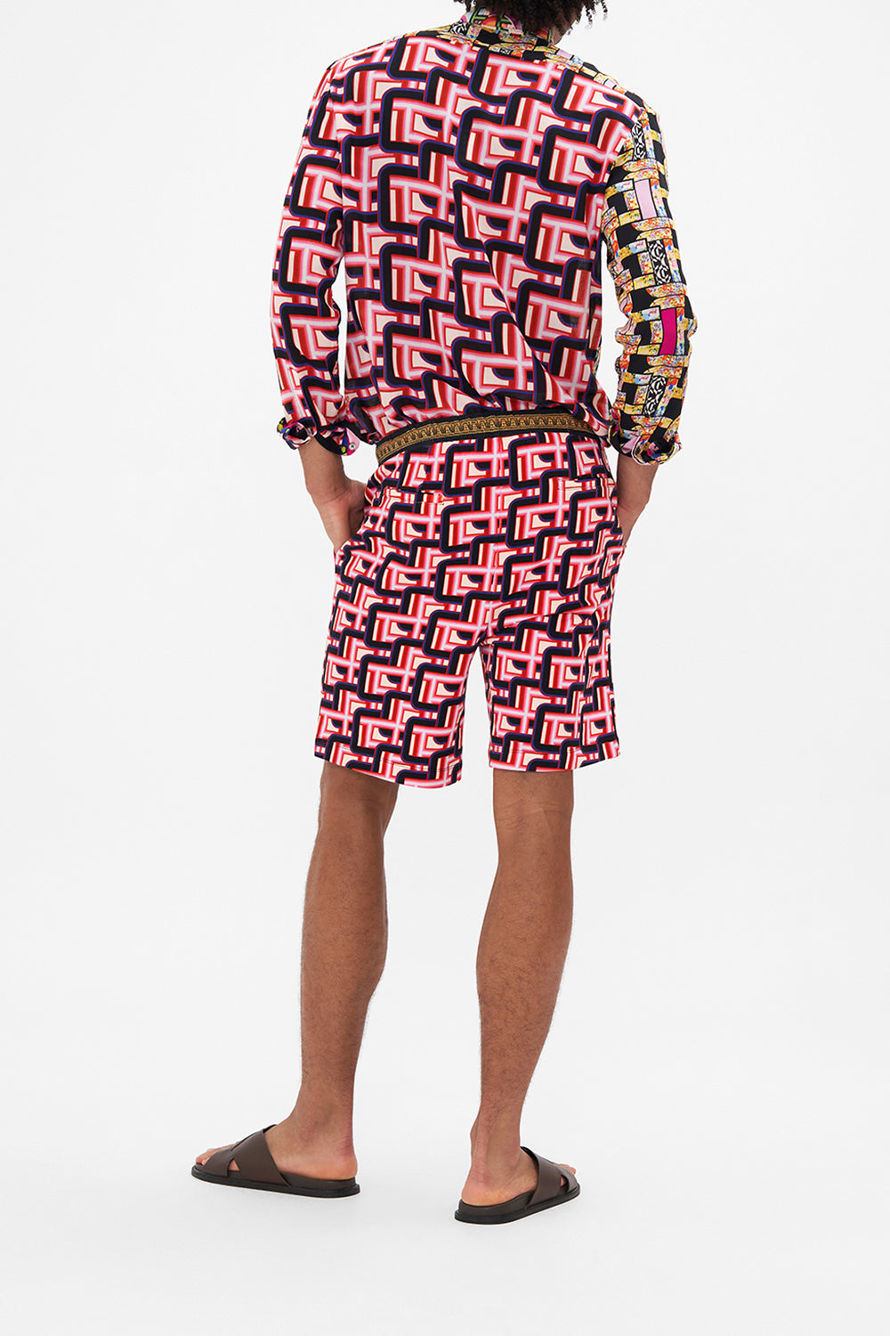 Back view of model wearing HOTEL FRANKS BY CAMILLA mens track short in Rome Retro print