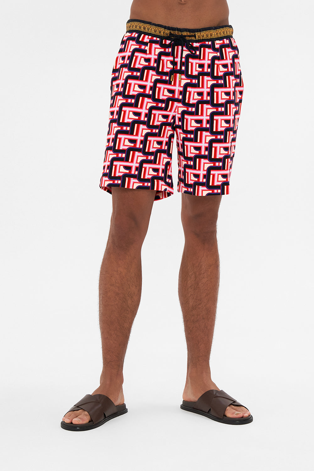 Crop view of model wearing HOTEL FRANKS BY CAMILLA mens track short in Rome Retro print