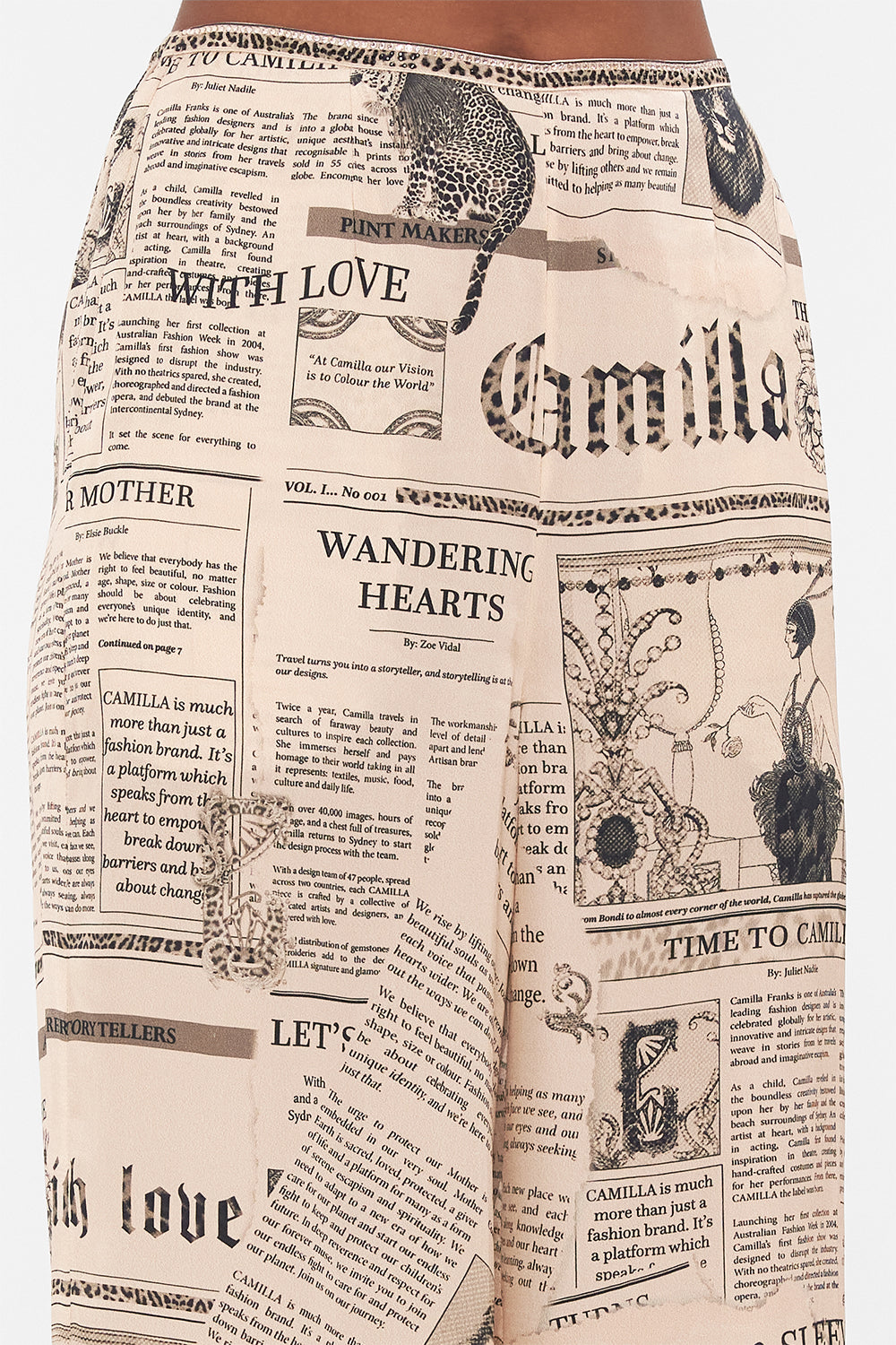 Detail view of model wearing CAMILLA pink silk pants in Fame Fever print