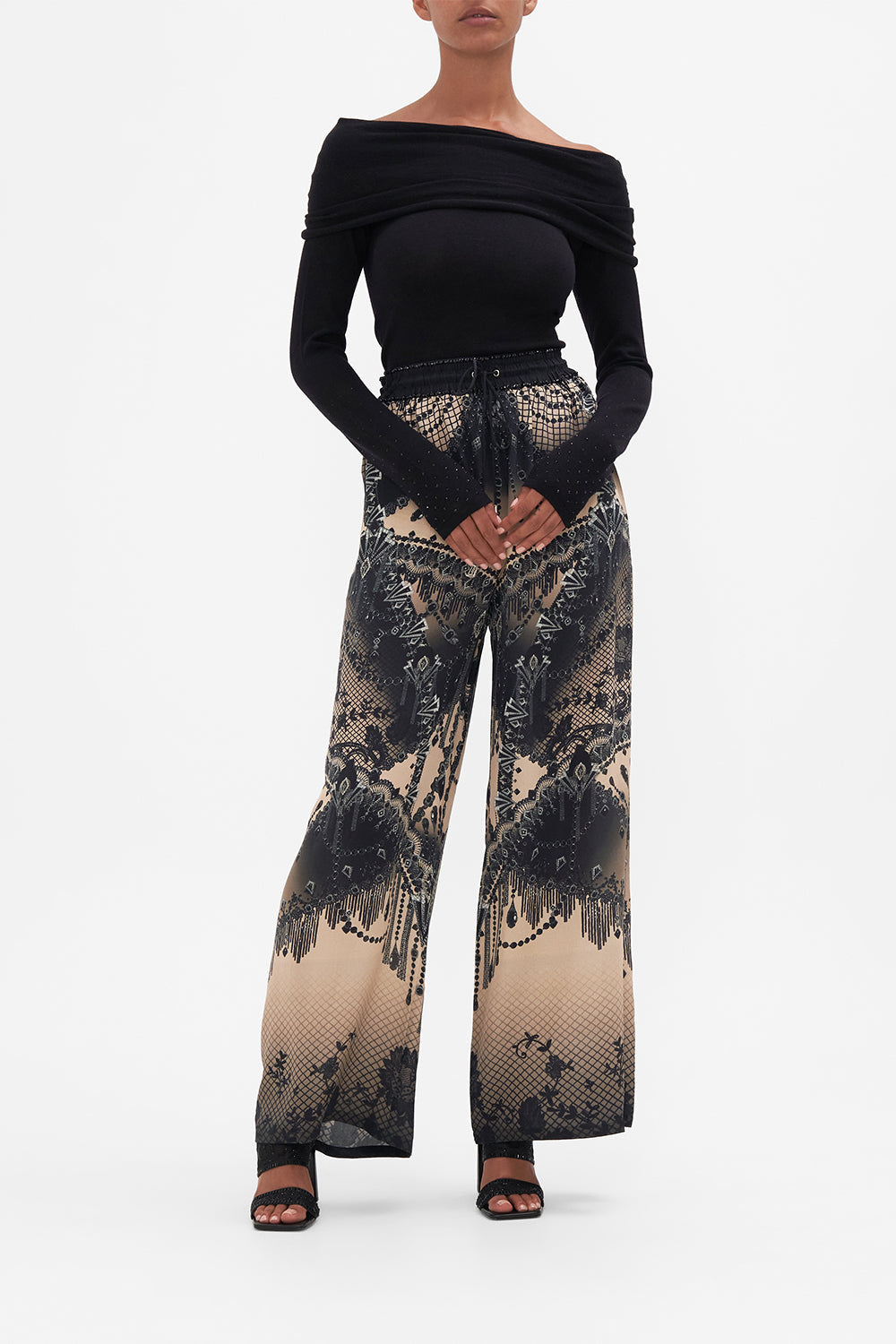 Front view of model wearing CAMILLA off shoulder knit in Curtain Call Chaos print