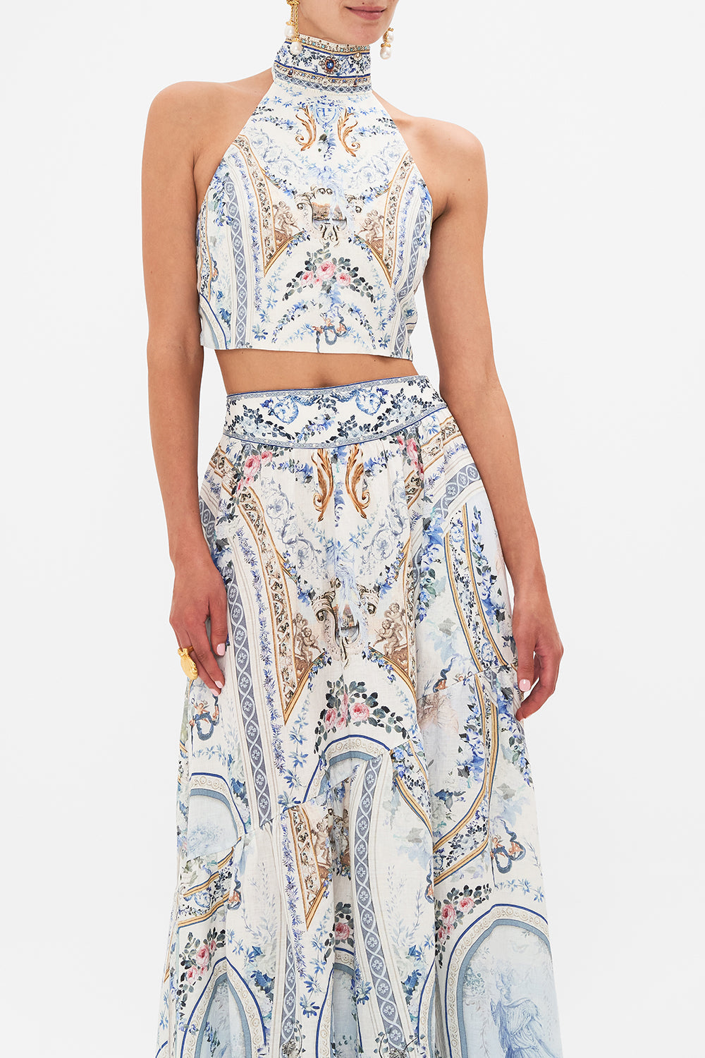 Crop view of model wearing CAMILLA designer halter top in Season of The Siren print