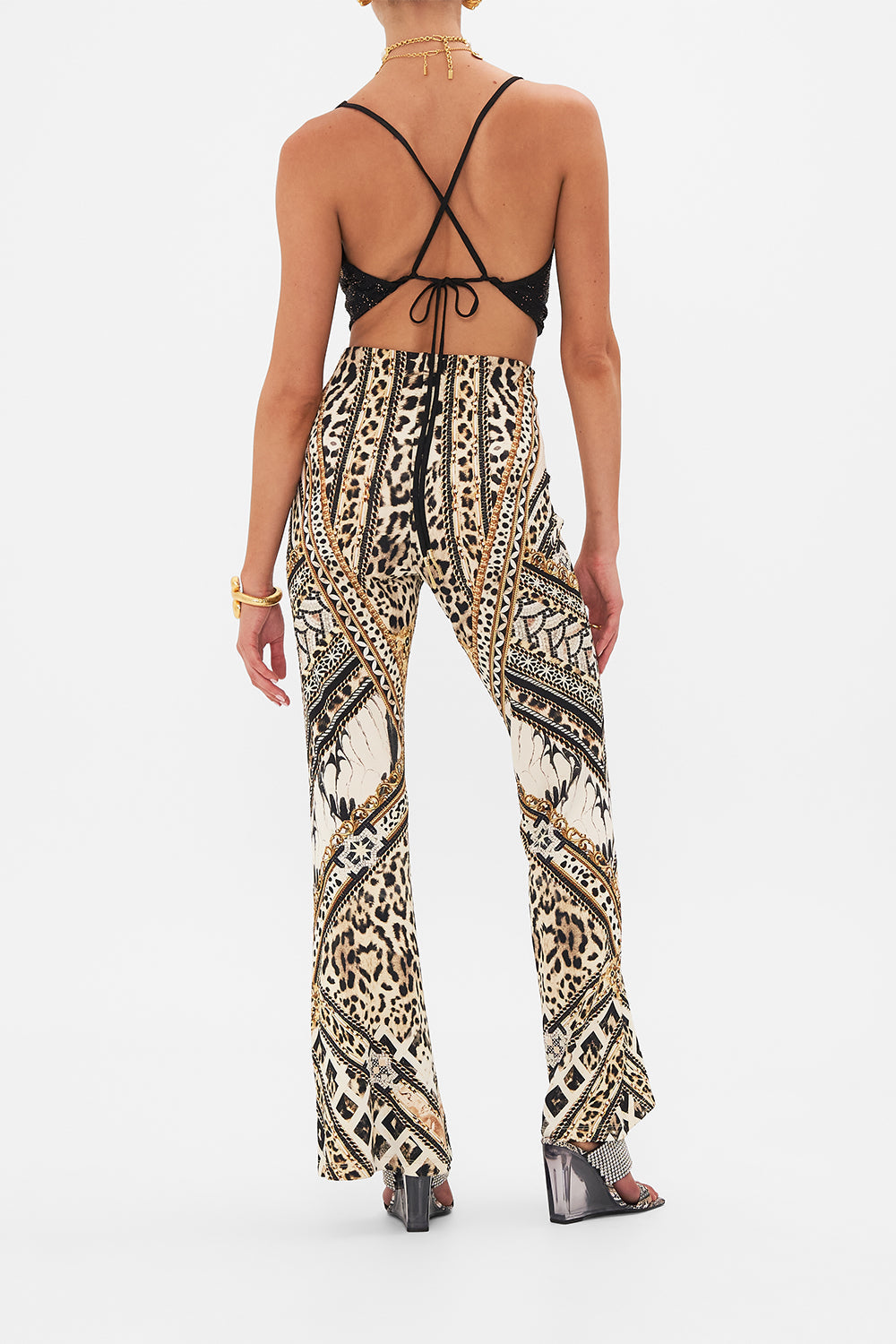 Back view of model wearing CAMILLA flare pant in Mosaic Muse print