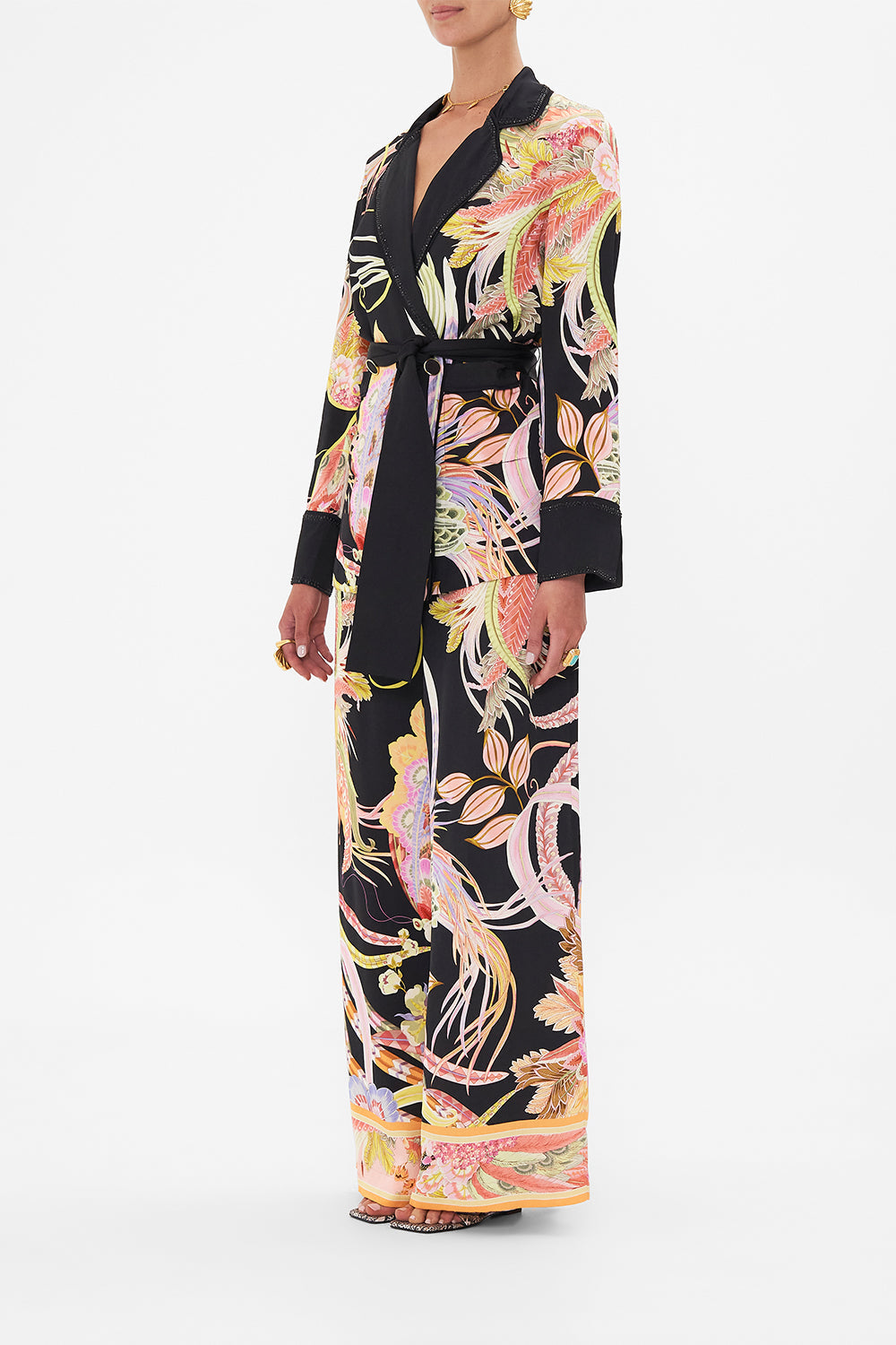 Side view of model wearing CAMILLA deisgner jacket in lady of The Moon Print