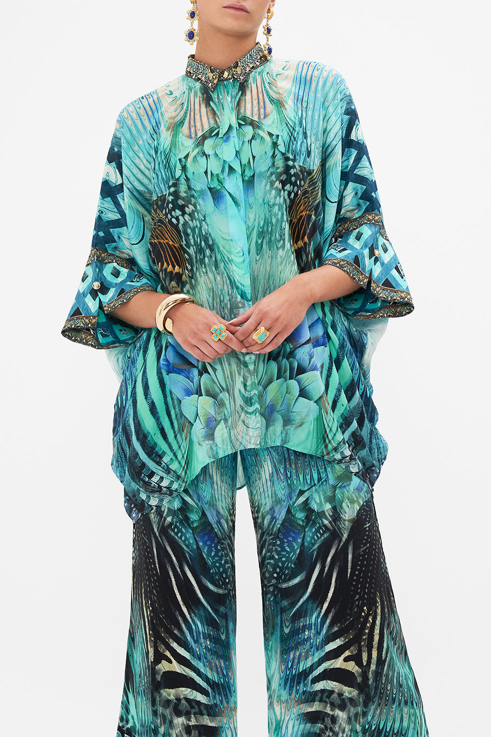 Crop view of model wearing CAMILLA silk shirt in Azure Allure print