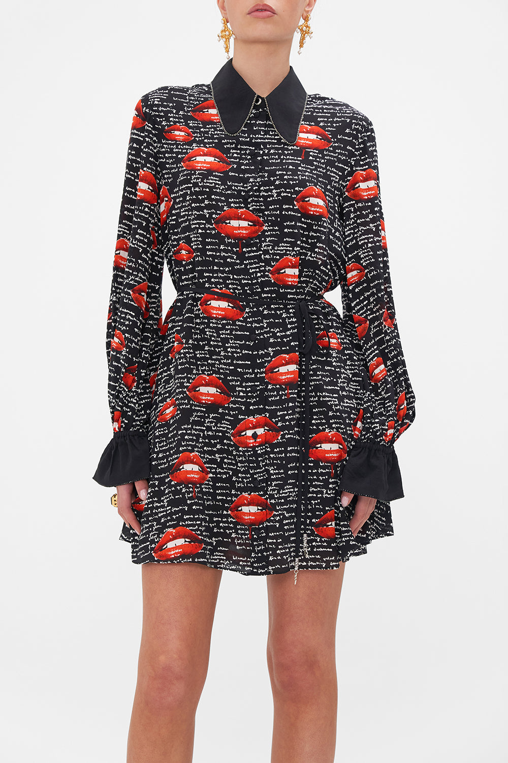 Crop view of model wearing CAMILLA black silk shirt dress in Chaos Magic print