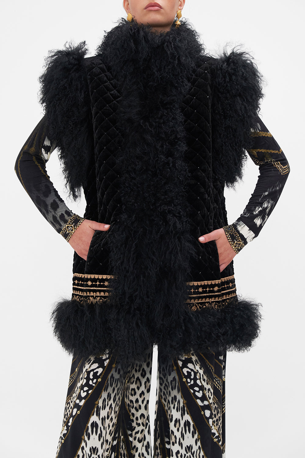 Crop view of model wearing CAMILLA black fur vest in Untamed Royalty print