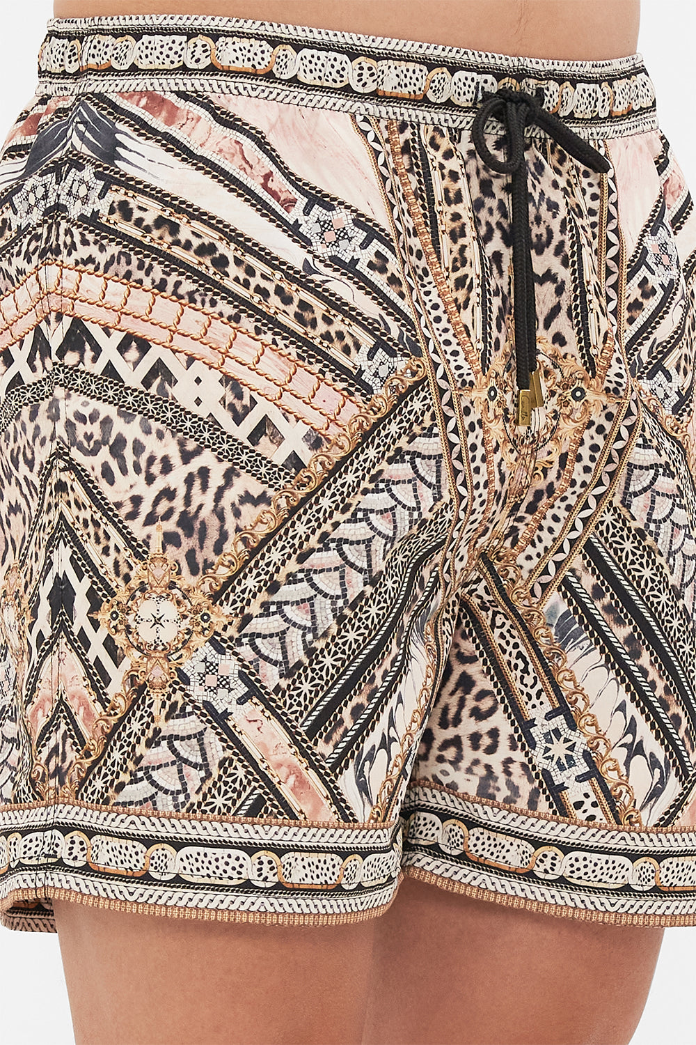 Detail view of model wearing Hotel Franks By CAMILLA mens boardshorts in mosaic muse print