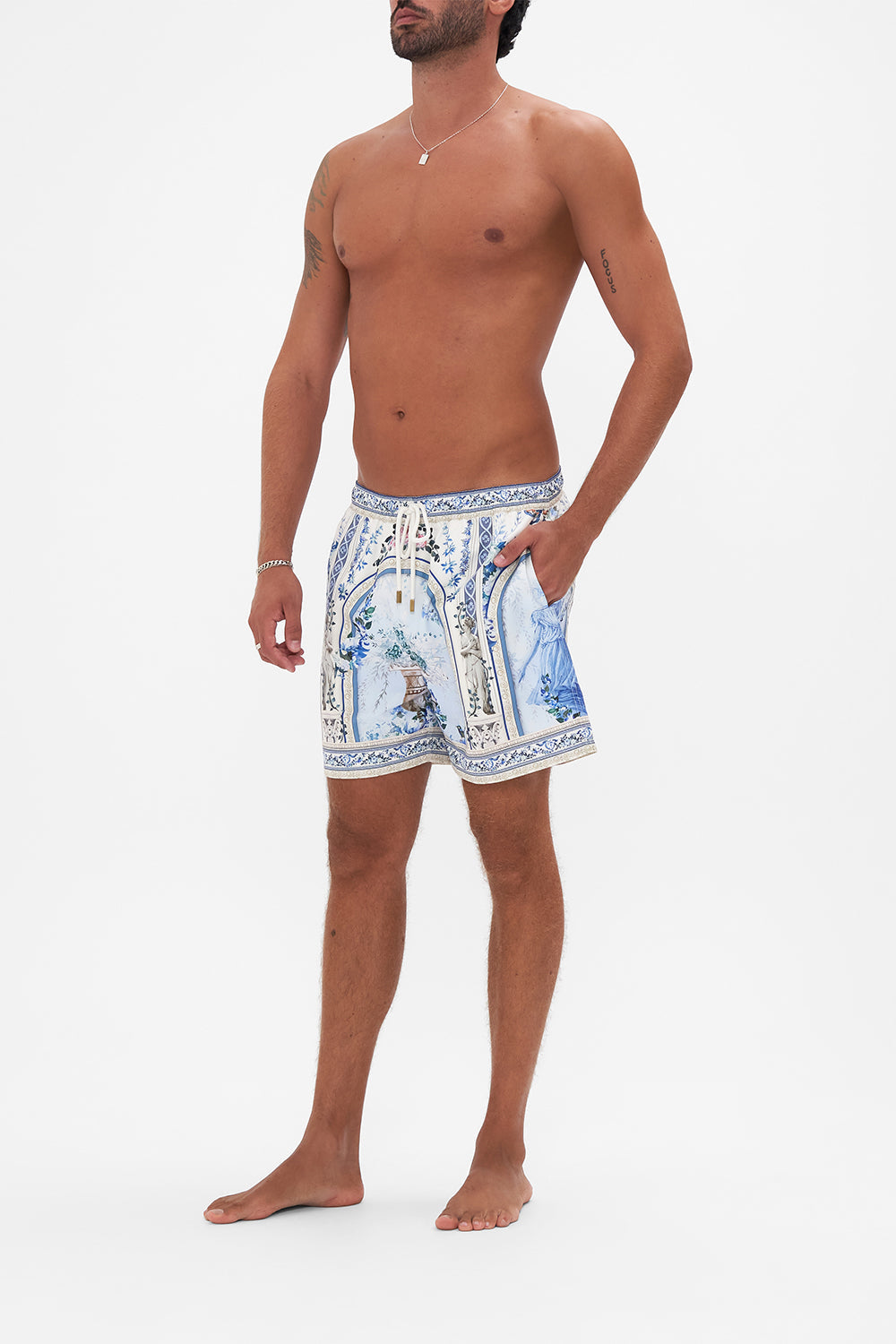 Side view of model wearing Hotel Franks by CAMILLA mens boardshort in Season Of The Siren print