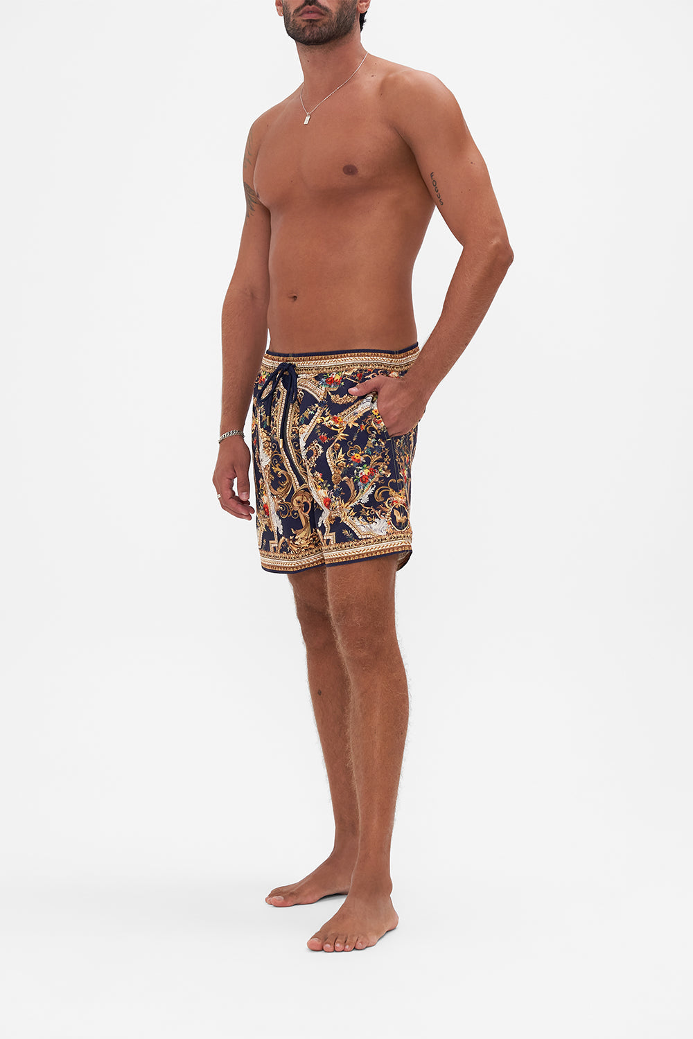 Side view of model wearing Hotel Franks by CAMILLA mens boardshort in Venice Vignette print