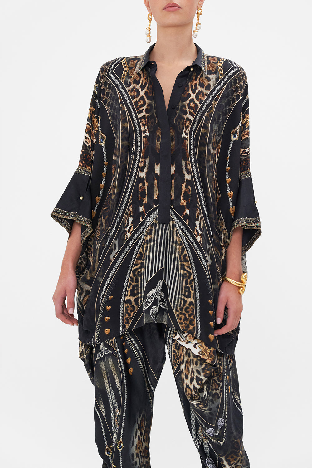 Crop view of model wearing CAMILLA silk shirt in Chaos In The Cosmos animal print