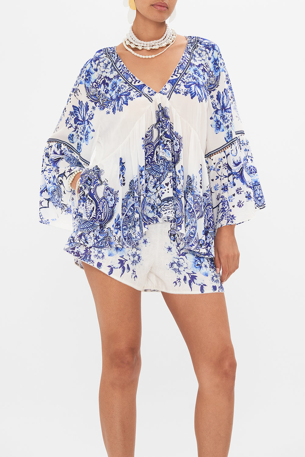 Crop view of model wearing CAMILLA silk ruffle blouse in Glaze And Graze print