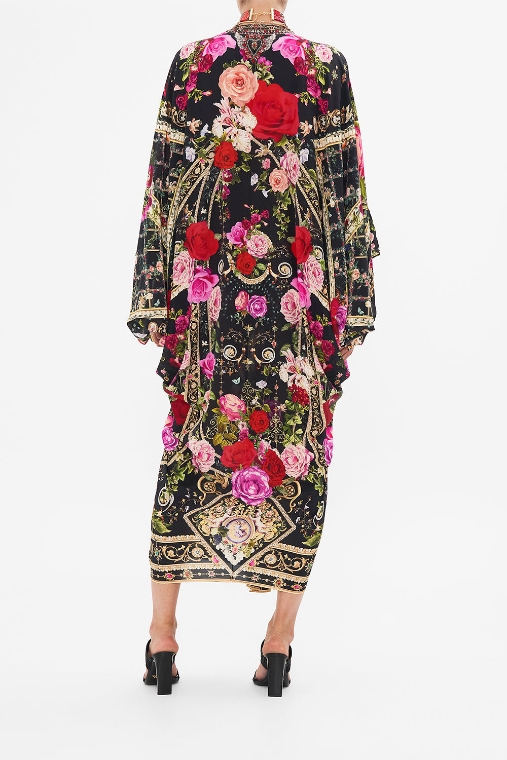 Back view of model wearing CAMILLA designer resort wear silk kaftan print in Reservation For Love print