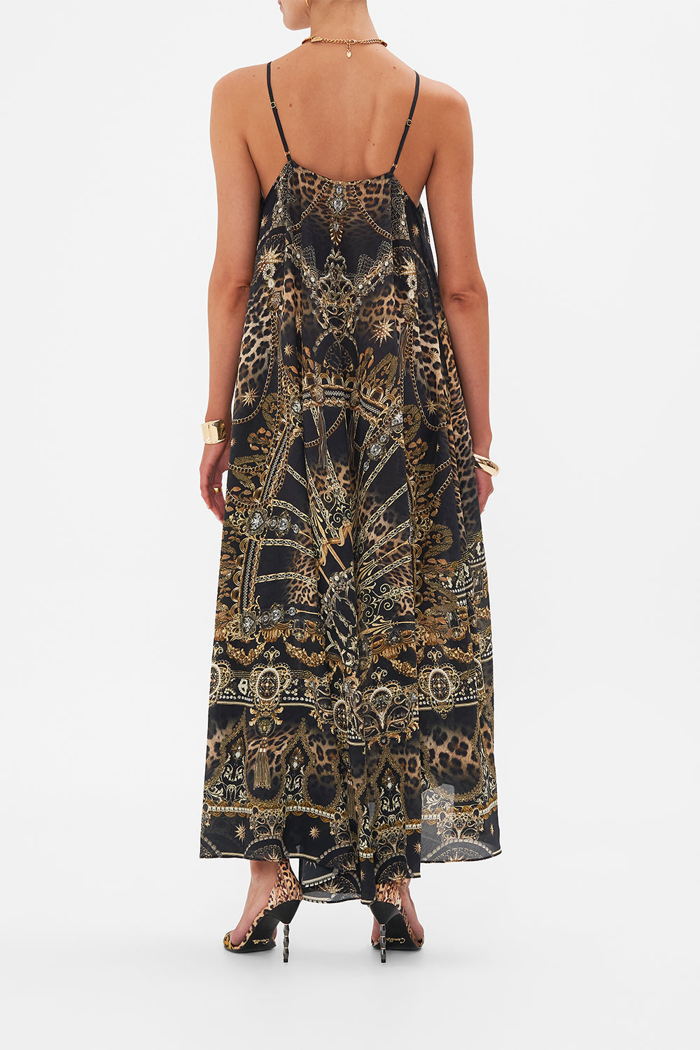 Back view of model wearing CAMILLA designer halterneck maxi dress in masked At Moonlight print