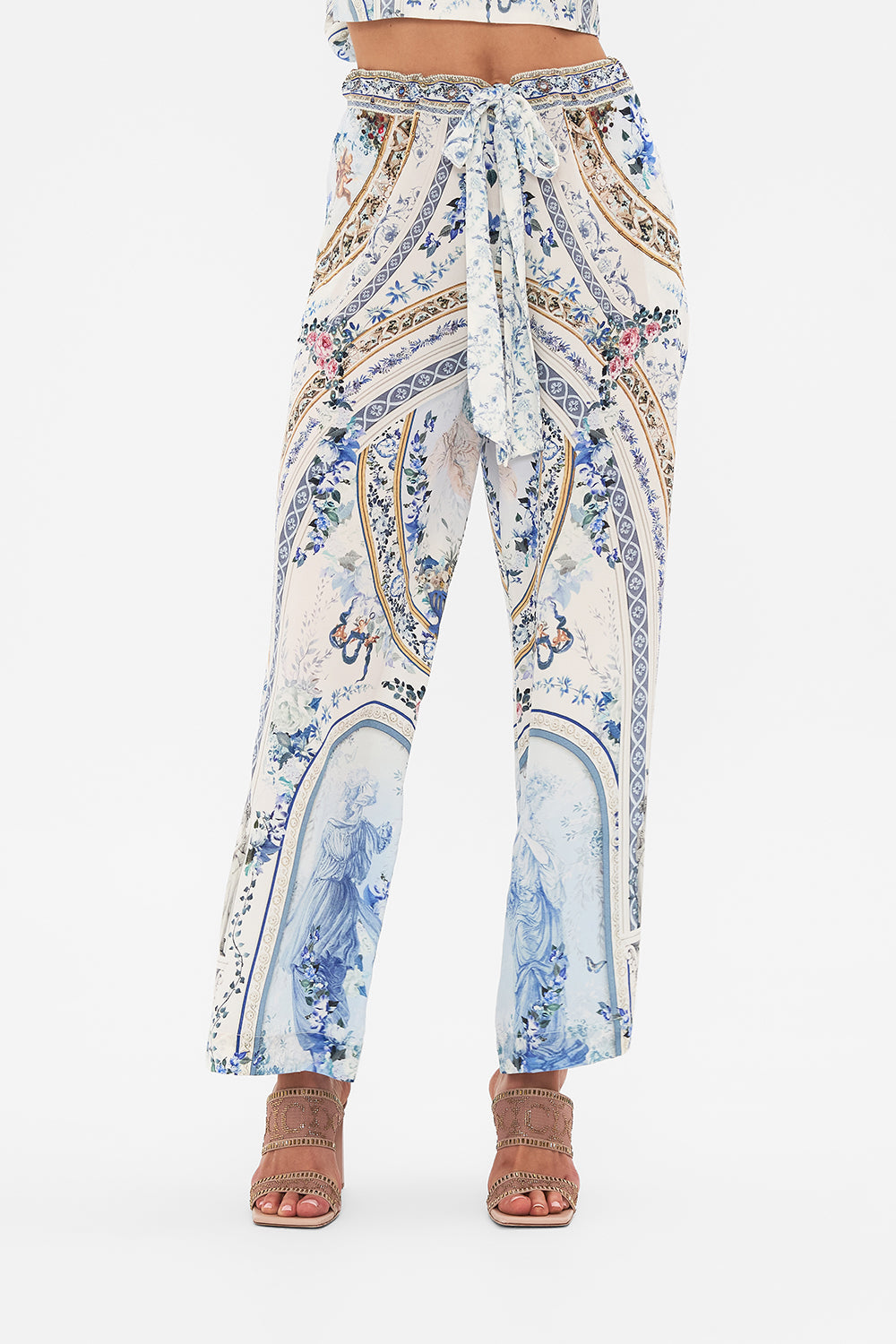 Detail view of model wearing CAMILLA blue silk pants in Season Of The Siren print