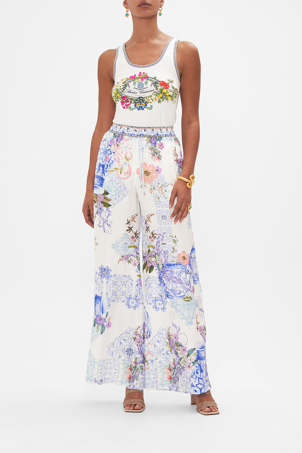 Front view of model wearing CAMILLA printed silk pants in Paint Me Positano print