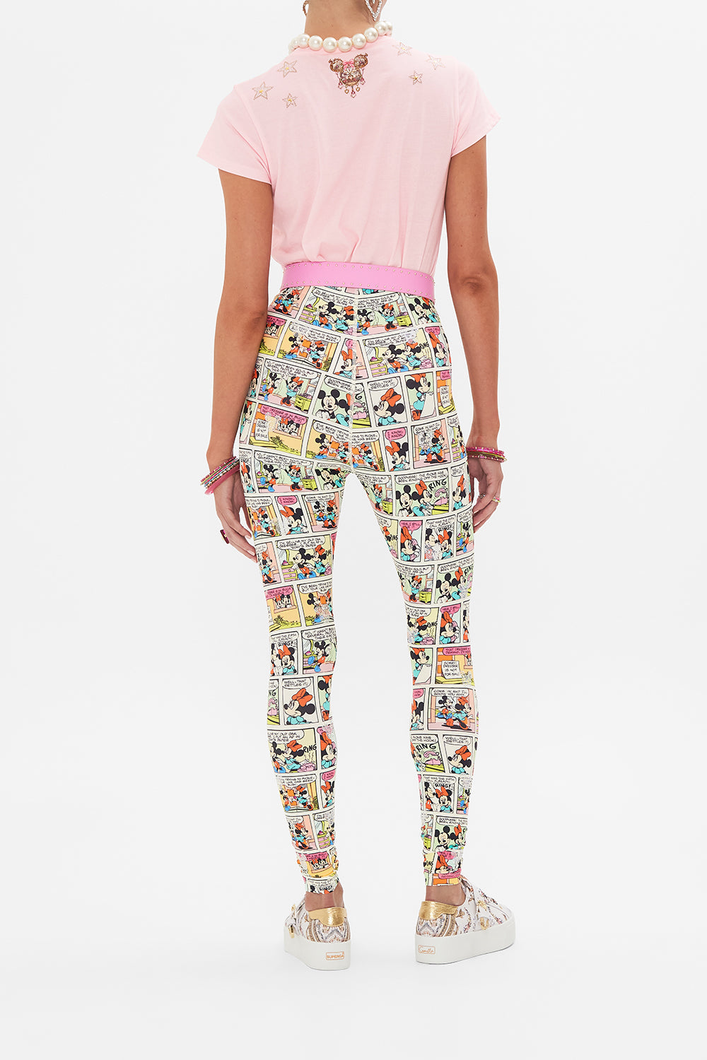 Back view of model wearing CAMILLA x Disney leggings in A Trip Down Comic Strip print