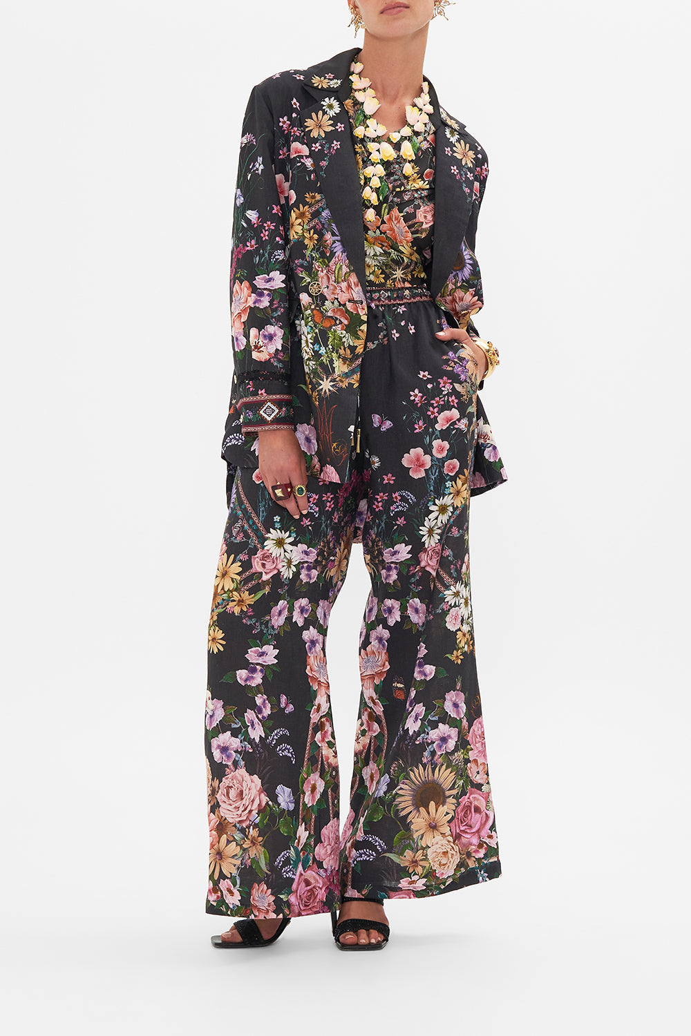 Detail view of model wearing CAMILLA silk jacket in Letters From A Vineyard print