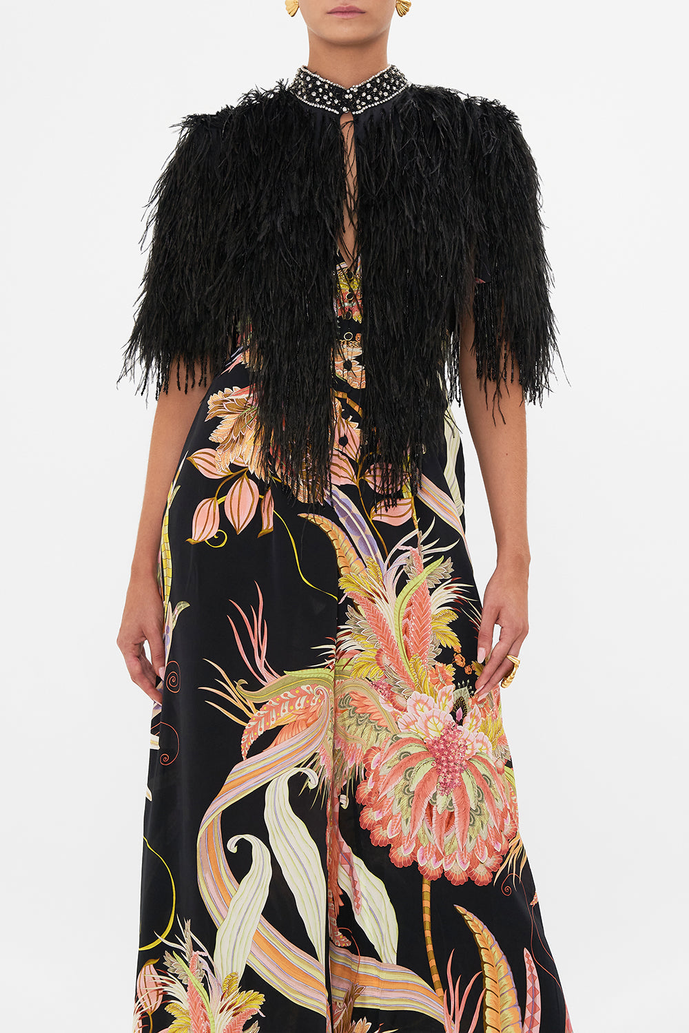 Crop view of model wearing CAMILLA beaded feather gilet in Lady of The Moon print