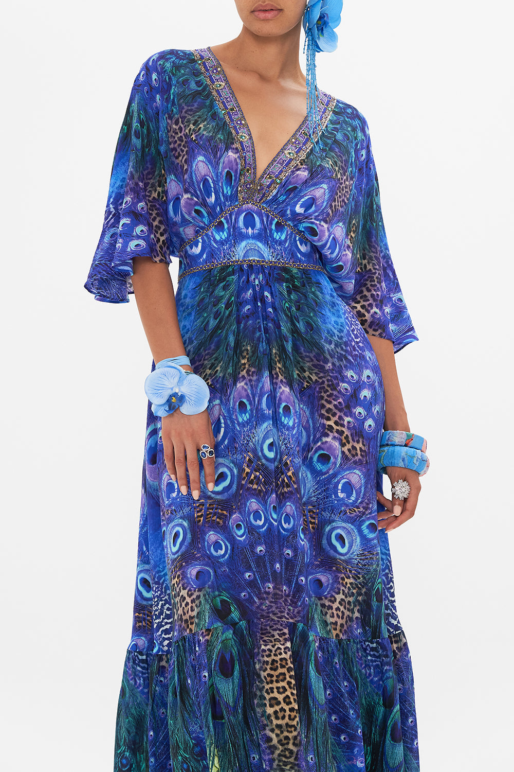Crop view of model wearing CAMILLA silk ruffle dress in Peacock Rock print