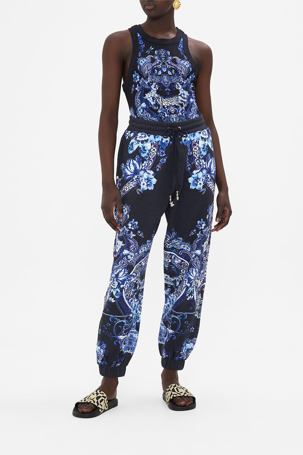 Front view of model wearing CAMILLA designer track pants in Delft Dynasty print 