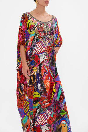 Crop view of model wearing CAMILLA silk kaftan in multicoloured Radical Rebirth print