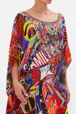 Detail view of model wearing CAMILLA silk kaftan in multicoloured Radical Rebirth print