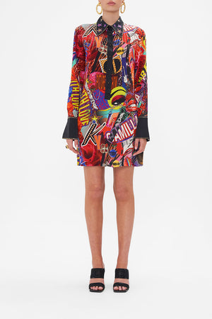 Front view of model wearing CAMILLA silk mini shirtdress in multicoloured Radical Rebirth print