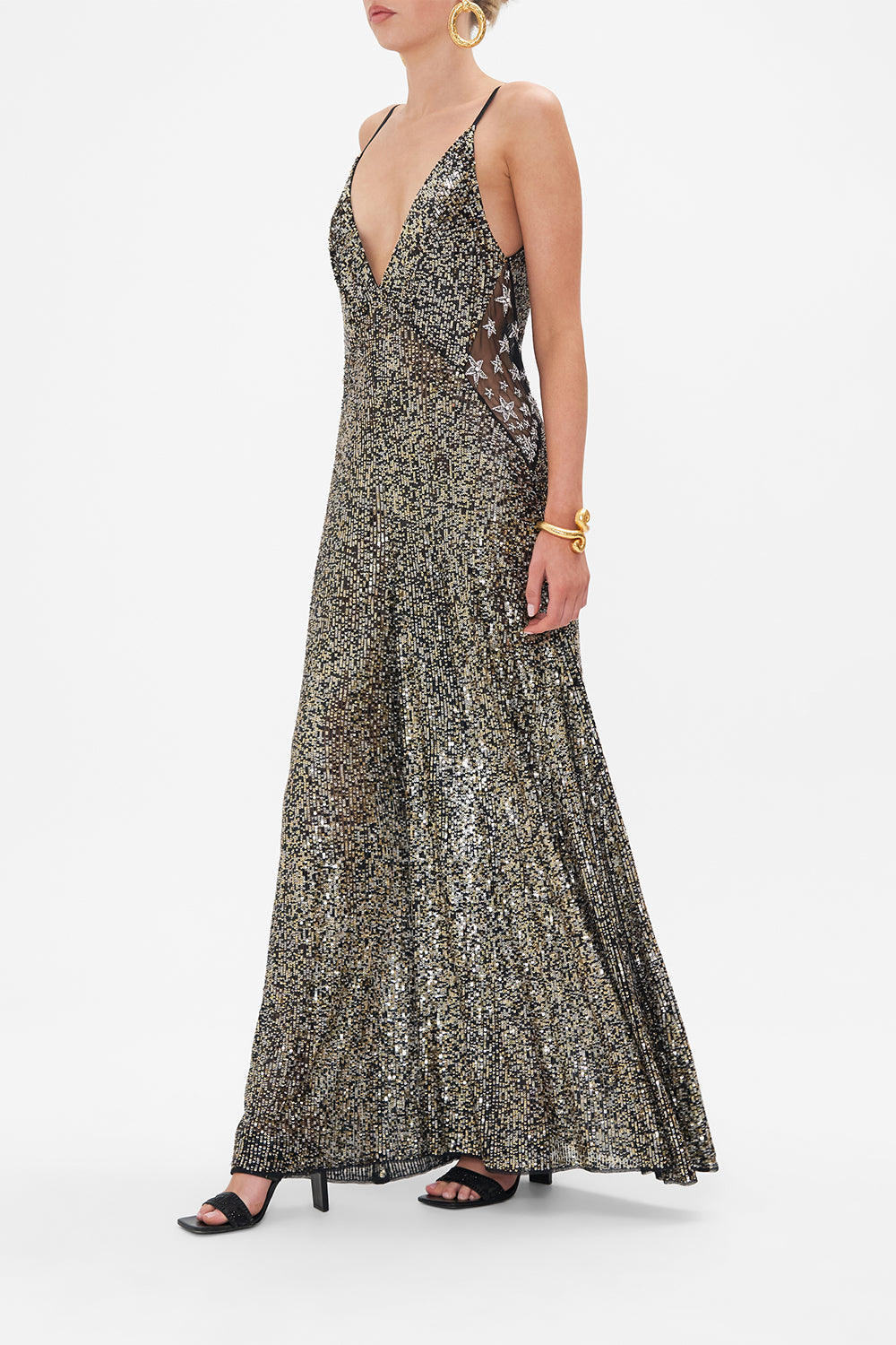 Side view of model wearing CAMILLA sequinned jumpsuit in Chaos In The Cosmos