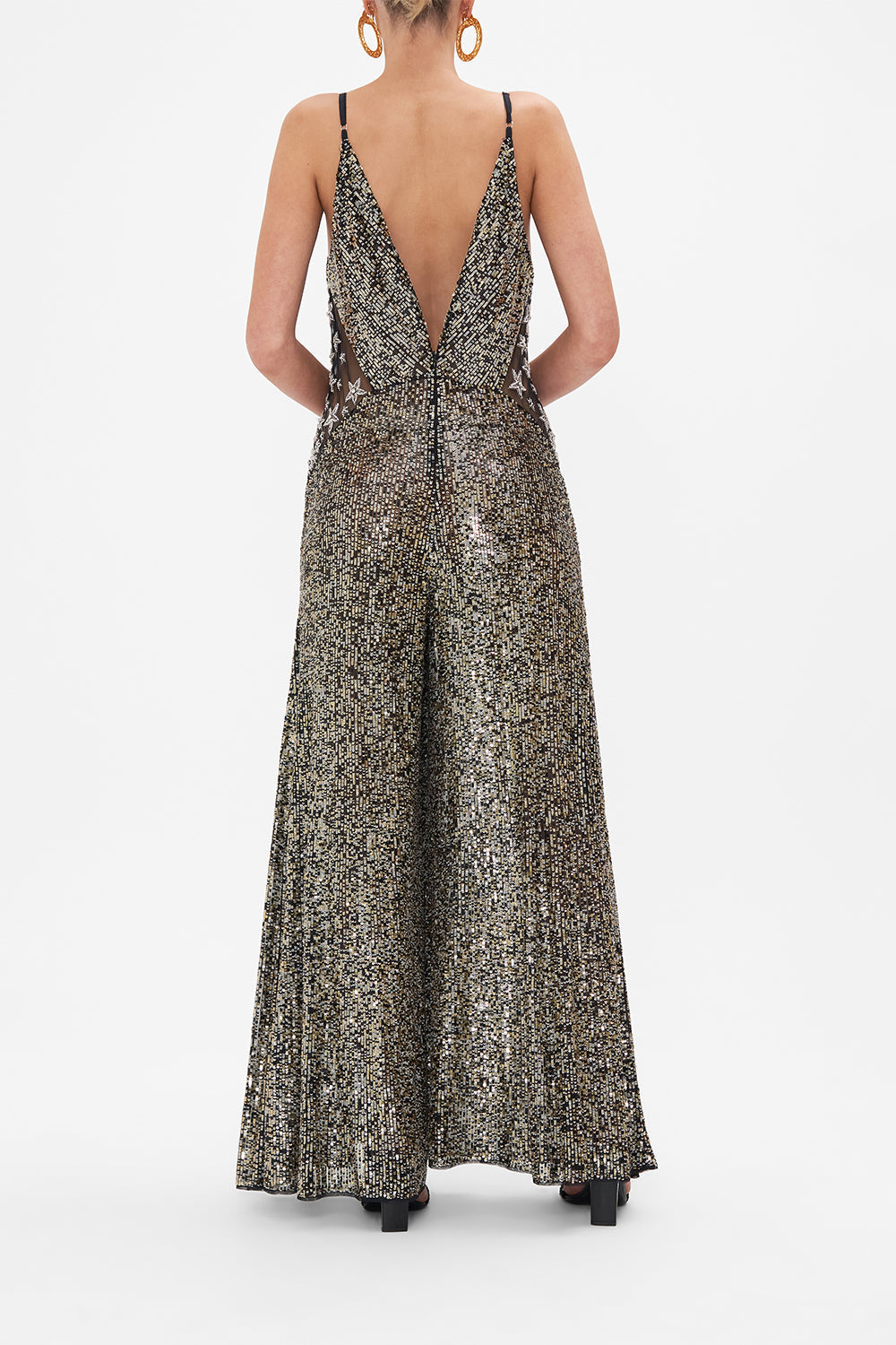 Back view of model wearing CAMILLA sequinned jumpsuit in Chaos In The Cosmos