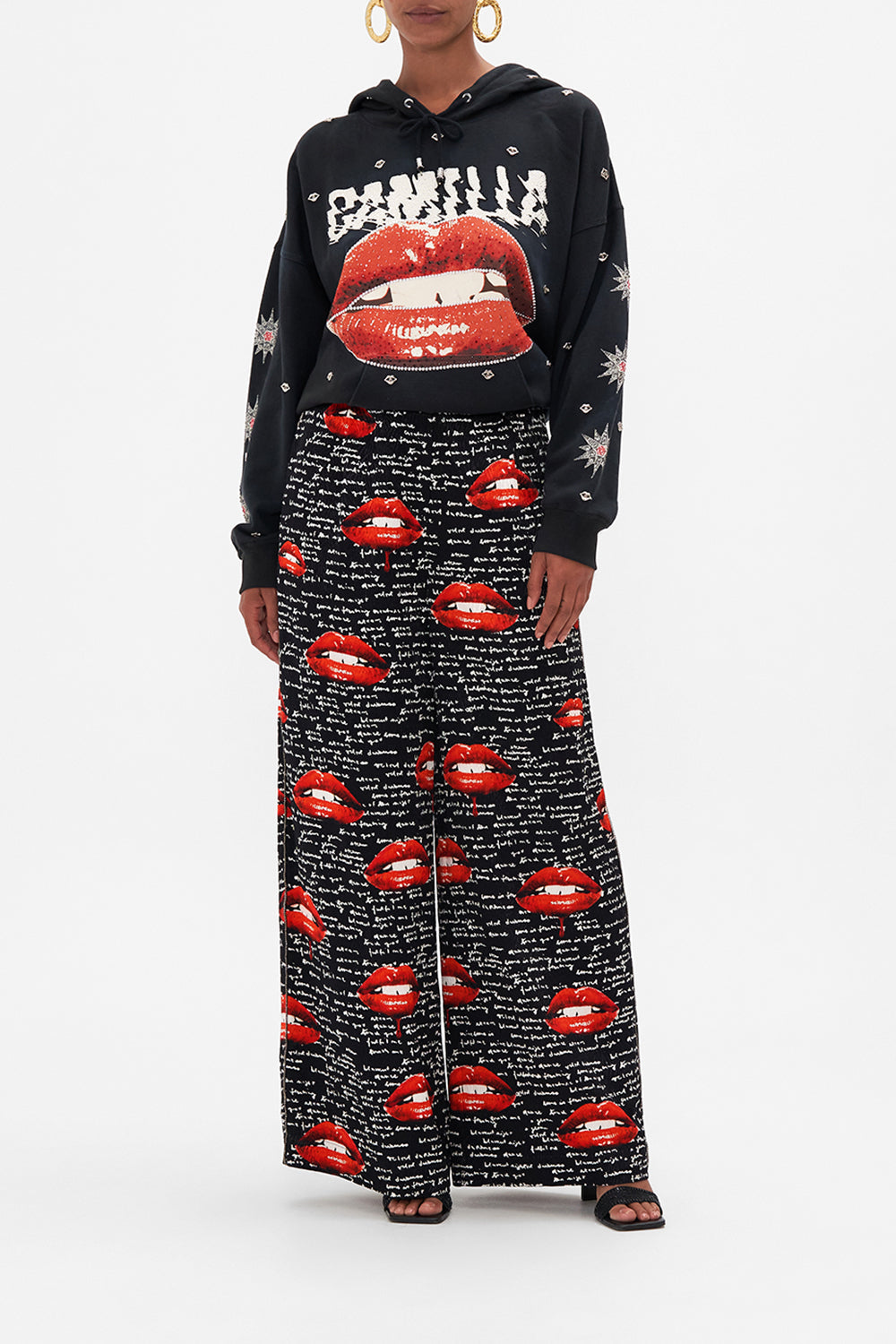 Front view of model wearing CAMILLA palazzo pants in black Chaos Magic  print